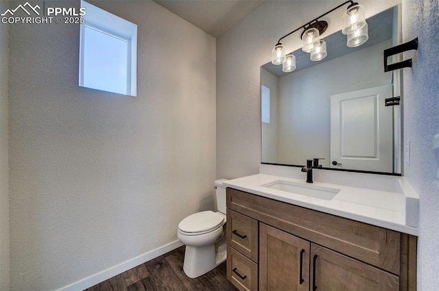 bathroom featuring hardwood / wood-style floors, vanity, and toilet