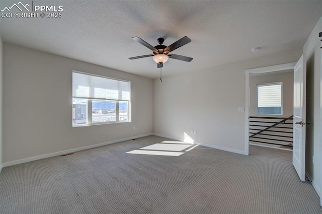 unfurnished room featuring ceiling fan and light colored carpet