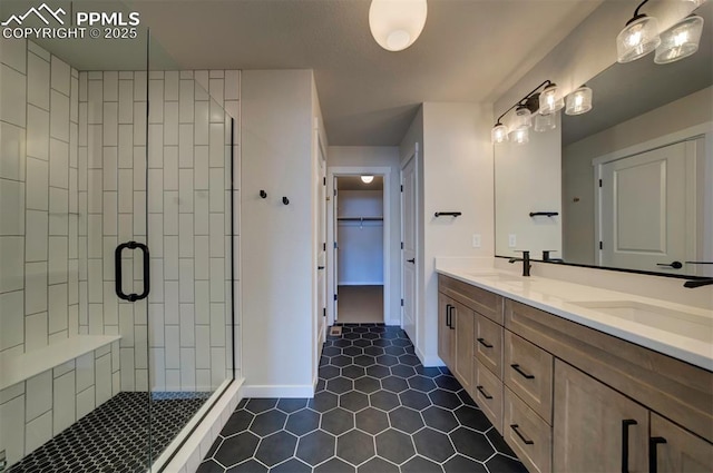 bathroom featuring tile patterned flooring, vanity, and a shower with door