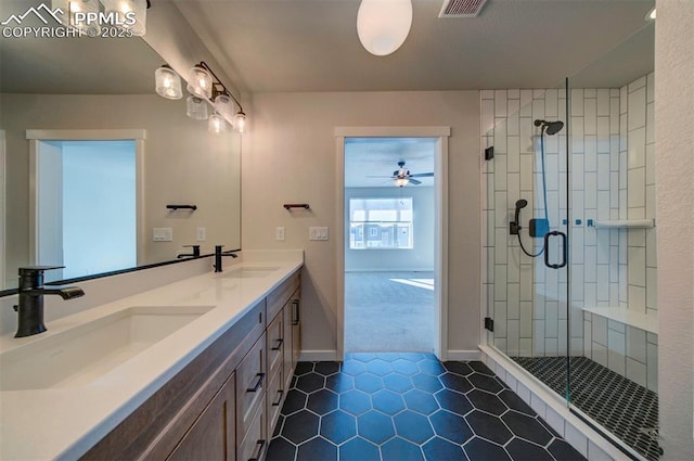 bathroom with tile patterned flooring, vanity, and walk in shower