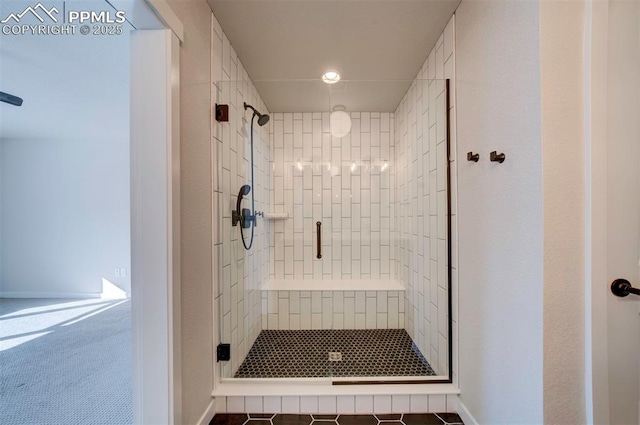 bathroom with tile patterned flooring and walk in shower