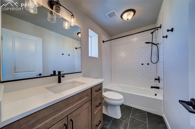 full bathroom with vanity, toilet, and tiled shower / bath