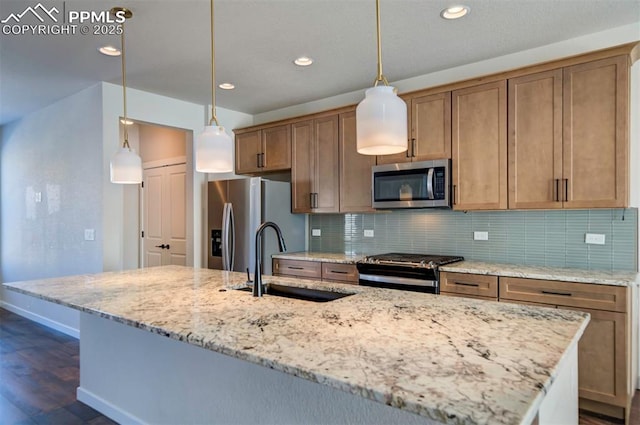 kitchen with decorative backsplash, light stone counters, stainless steel appliances, sink, and pendant lighting