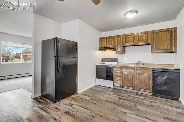 kitchen with black appliances, ceiling fan, light wood-type flooring, and sink