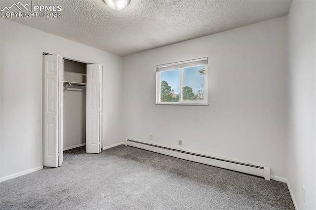 unfurnished bedroom featuring a textured ceiling, a baseboard radiator, a closet, and light colored carpet