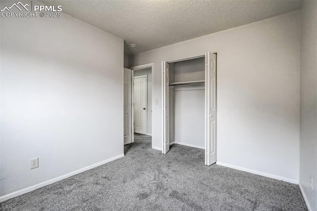 unfurnished bedroom featuring a textured ceiling, carpet floors, and a closet