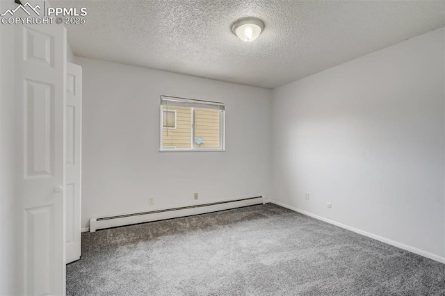 carpeted empty room featuring a textured ceiling and baseboard heating