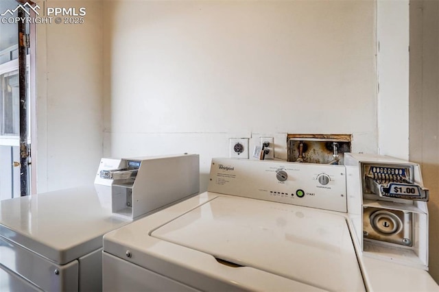 clothes washing area featuring washer and dryer