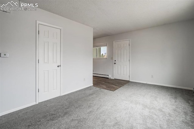 unfurnished room featuring a textured ceiling, baseboard heating, and carpet