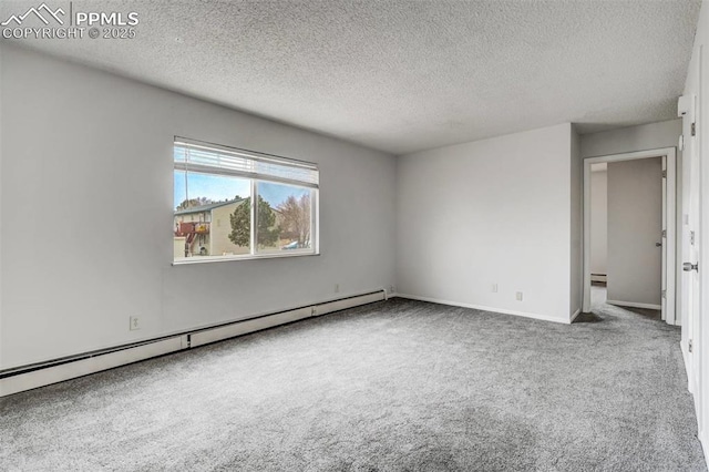 spare room with baseboard heating, carpet, and a textured ceiling