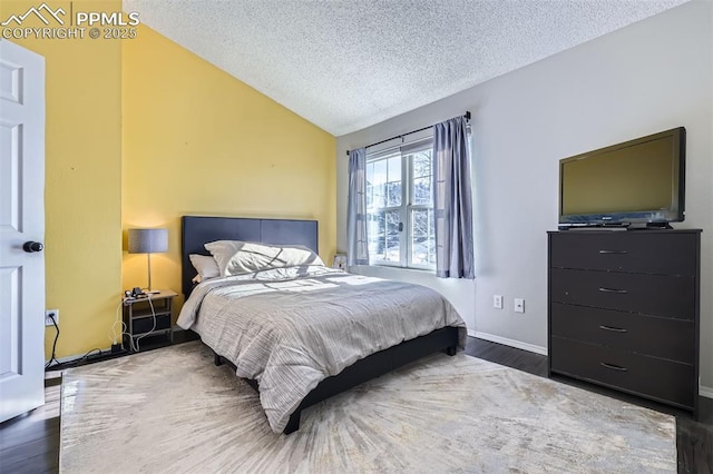 bedroom with dark hardwood / wood-style flooring, lofted ceiling, and a textured ceiling