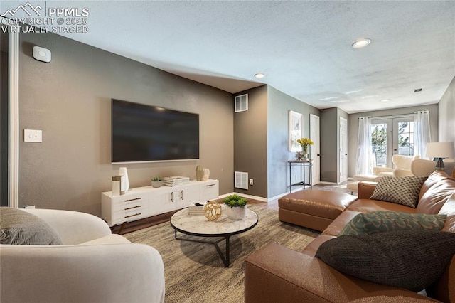 living room featuring light wood-type flooring and french doors