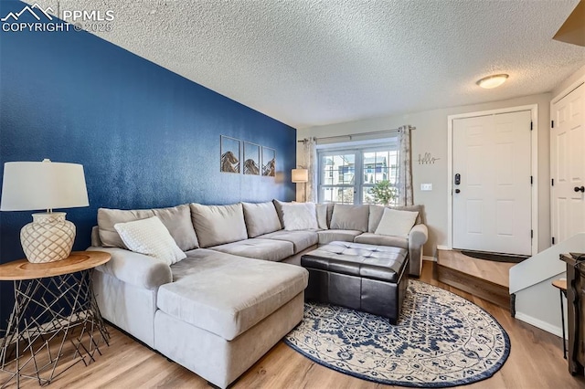 living room featuring wood-type flooring and a textured ceiling