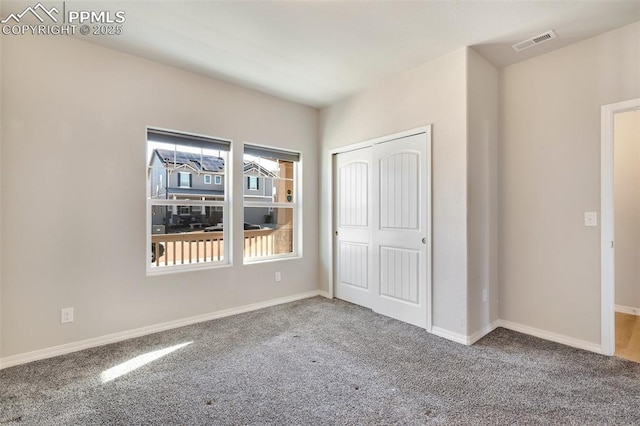 unfurnished bedroom featuring a closet and carpet floors