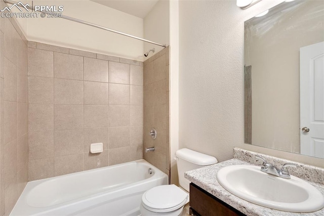 full bathroom with vanity, tiled shower / bath combo, and toilet