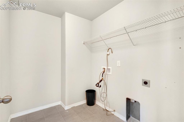 washroom with washer hookup, electric dryer hookup, and light tile patterned floors