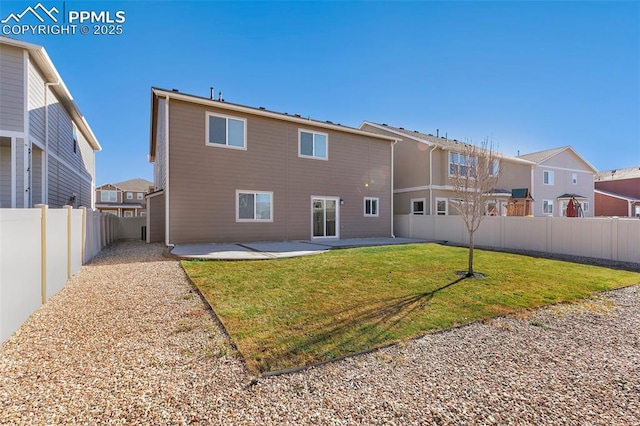 rear view of property with a yard and a patio