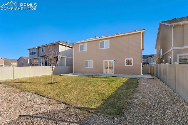 rear view of house with a lawn and a patio area