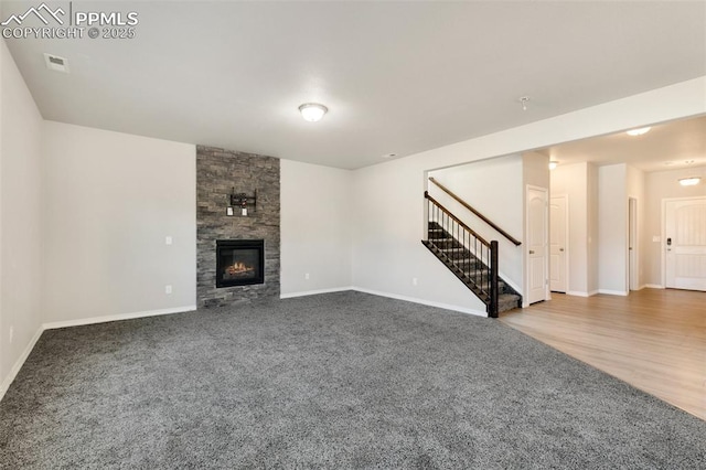 unfurnished living room with a fireplace and carpet floors