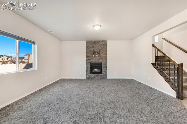 unfurnished living room with carpet and a large fireplace