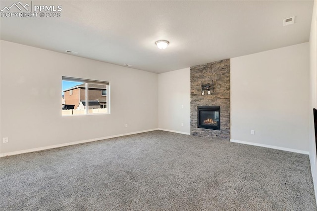 unfurnished living room featuring a fireplace and carpet