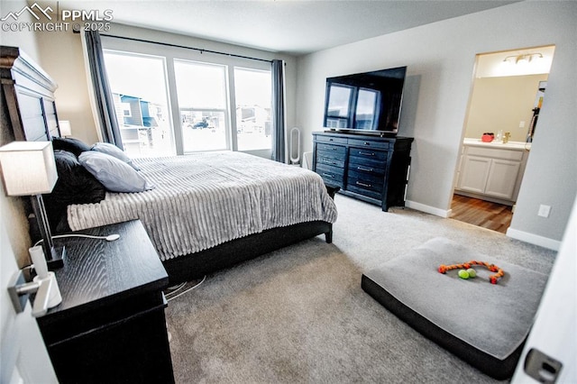 carpeted bedroom featuring connected bathroom