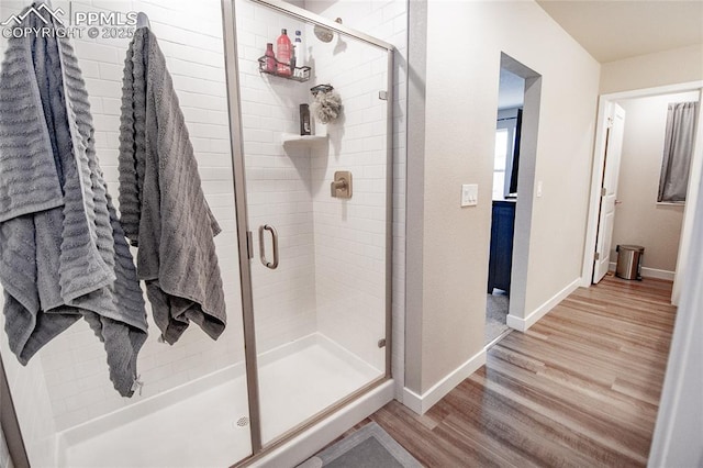 bathroom featuring hardwood / wood-style floors and walk in shower