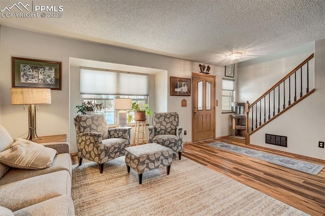 living room featuring hardwood / wood-style floors and a textured ceiling