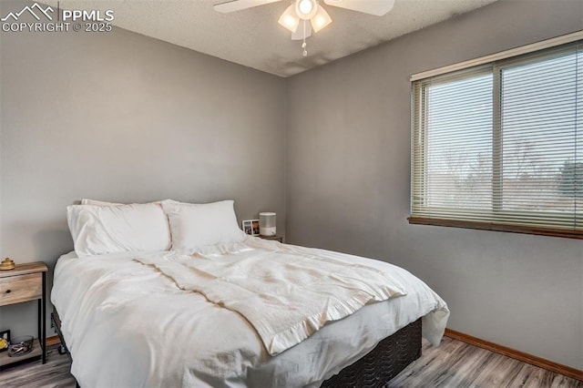 bedroom featuring hardwood / wood-style flooring and ceiling fan