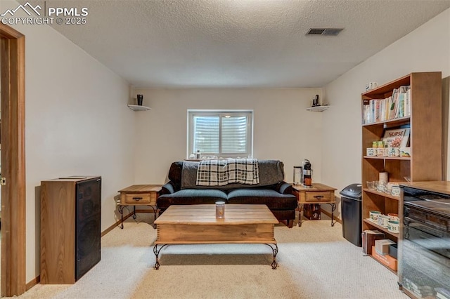 living room with light carpet and a textured ceiling