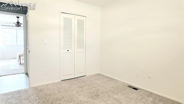 unfurnished bedroom featuring a closet and carpet floors