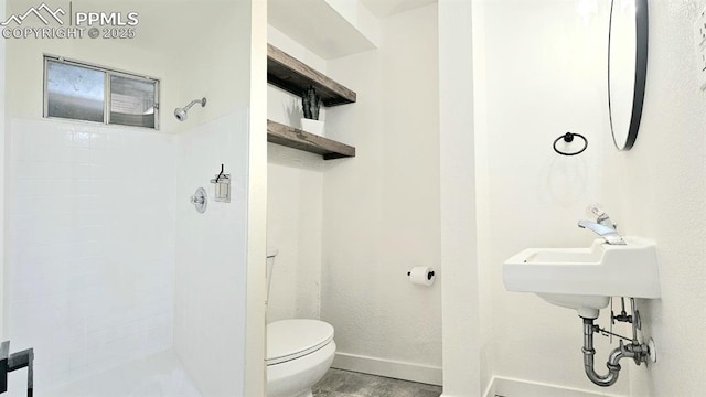 bathroom featuring toilet and walk in shower