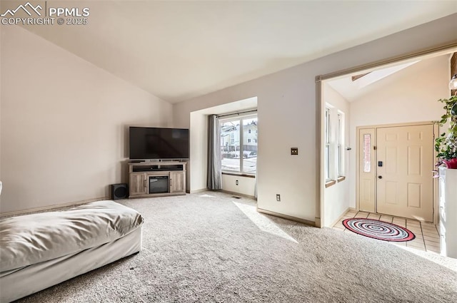 carpeted living room featuring vaulted ceiling