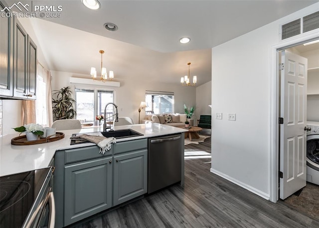 kitchen with a chandelier, appliances with stainless steel finishes, dark hardwood / wood-style flooring, and pendant lighting