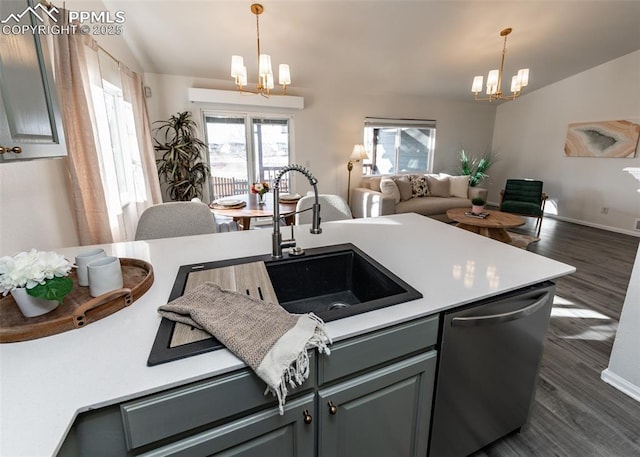 kitchen with dishwasher, an inviting chandelier, sink, dark hardwood / wood-style floors, and gray cabinets