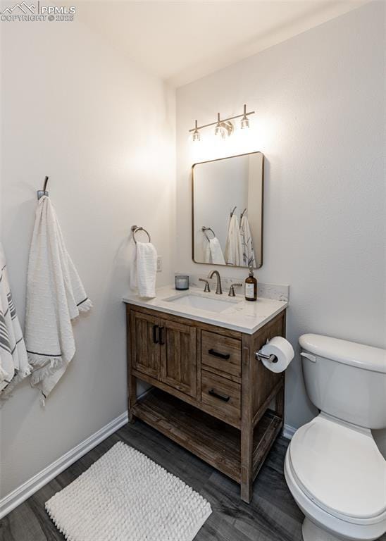 bathroom featuring hardwood / wood-style floors, vanity, and toilet