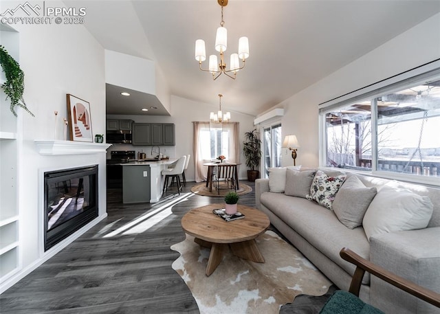 living room featuring a notable chandelier, lofted ceiling, and dark wood-type flooring