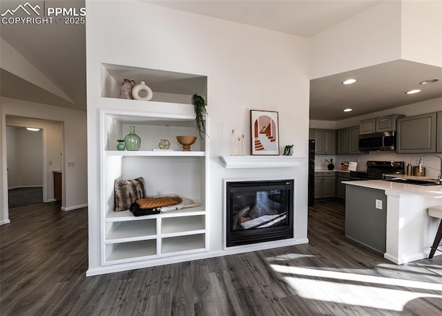 kitchen featuring refrigerator, gray cabinetry, dark wood-type flooring, built in features, and black range with electric stovetop