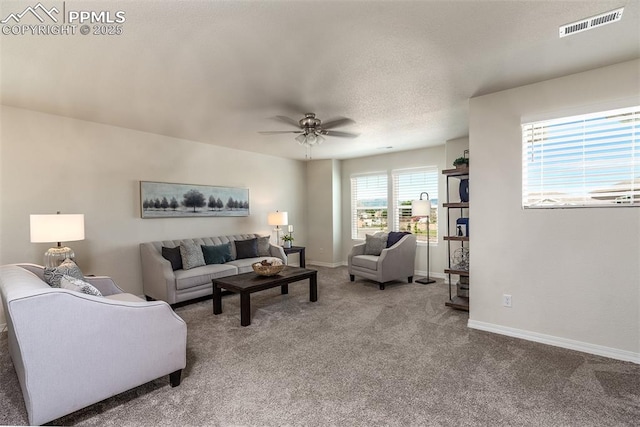 living room featuring ceiling fan and carpet