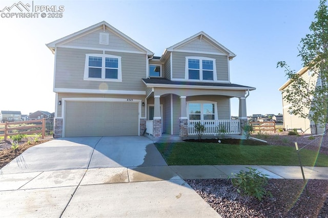 craftsman house featuring a front yard, a porch, and a garage