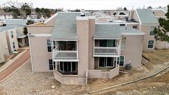 back of house featuring central AC