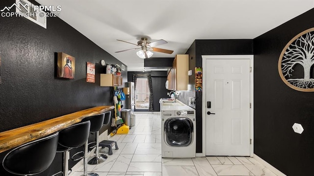 laundry room featuring washer / dryer, water heater, ceiling fan, and sink