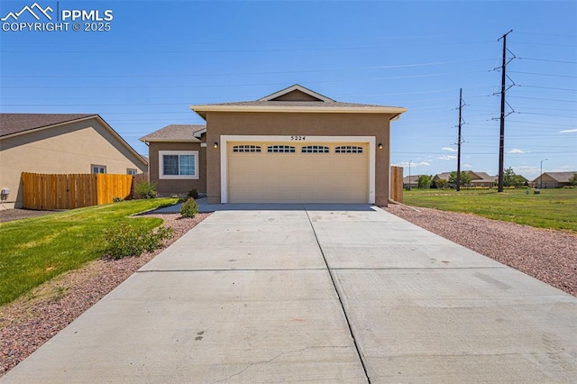 view of front facade featuring a front yard and a garage