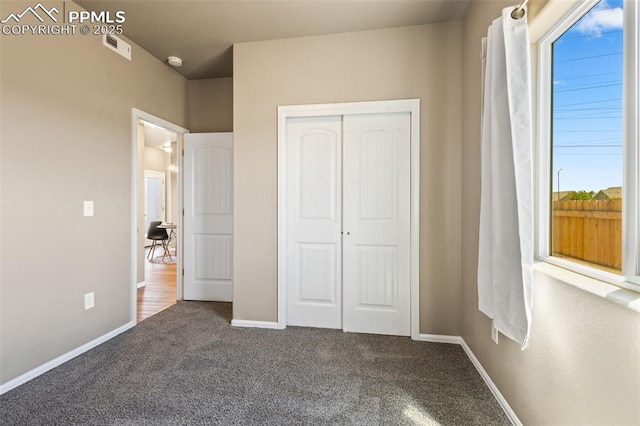 unfurnished bedroom with carpet and a closet