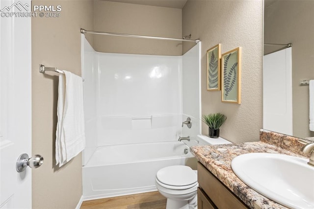 full bathroom featuring toilet, vanity, bathing tub / shower combination, and wood-type flooring