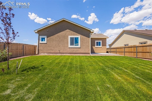 rear view of house featuring a lawn