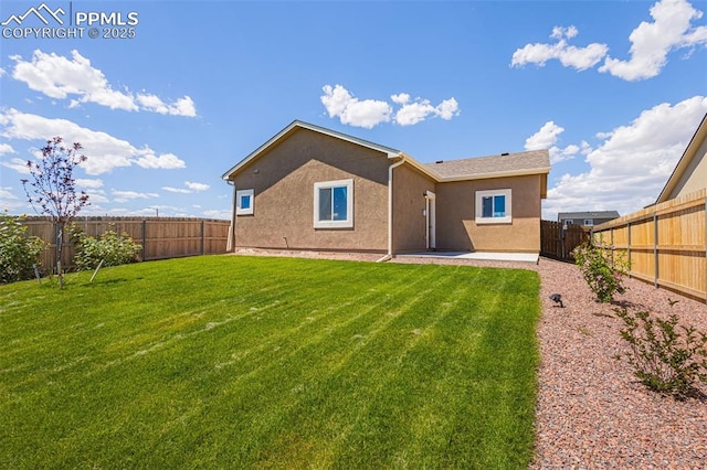 rear view of house featuring a lawn