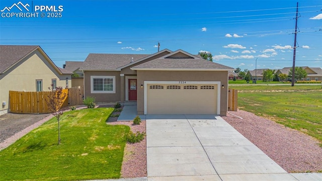 single story home featuring a front lawn and a garage