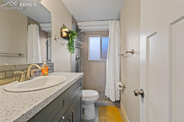 bathroom featuring toilet, tile patterned flooring, vanity, and curtained shower