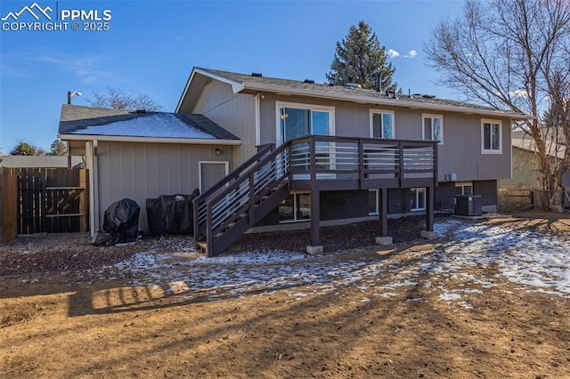 back of property with cooling unit and a wooden deck